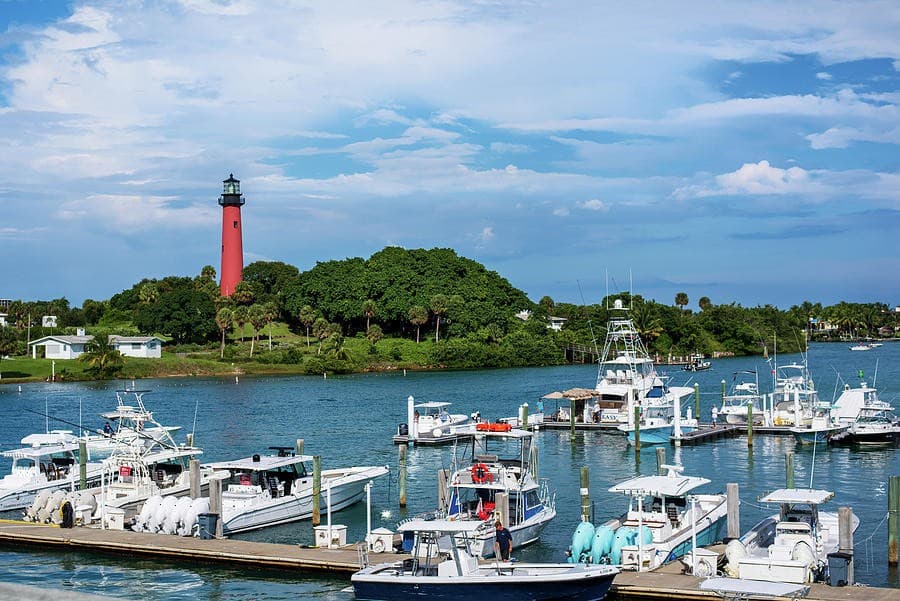 Jupiter Inlet Lighthouse overlooking the marina, full of sportfish boats at dock