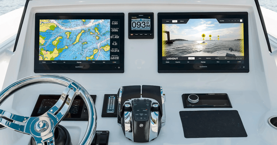 Sportfish helm with Garmin MFDs, autopilot heading display, and steering wheel