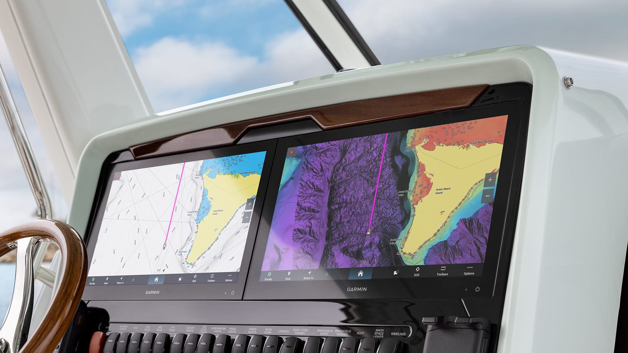 Dual Garmin chartplotter displays at a sportfish helm showing chart and sonar chart layers