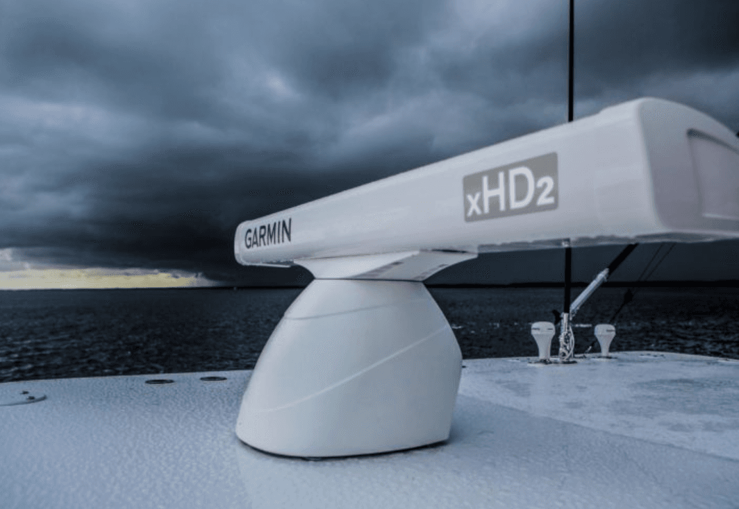 Garmin xHD2 open-array radar mounted on a boat tower against a dramatic stormy sky