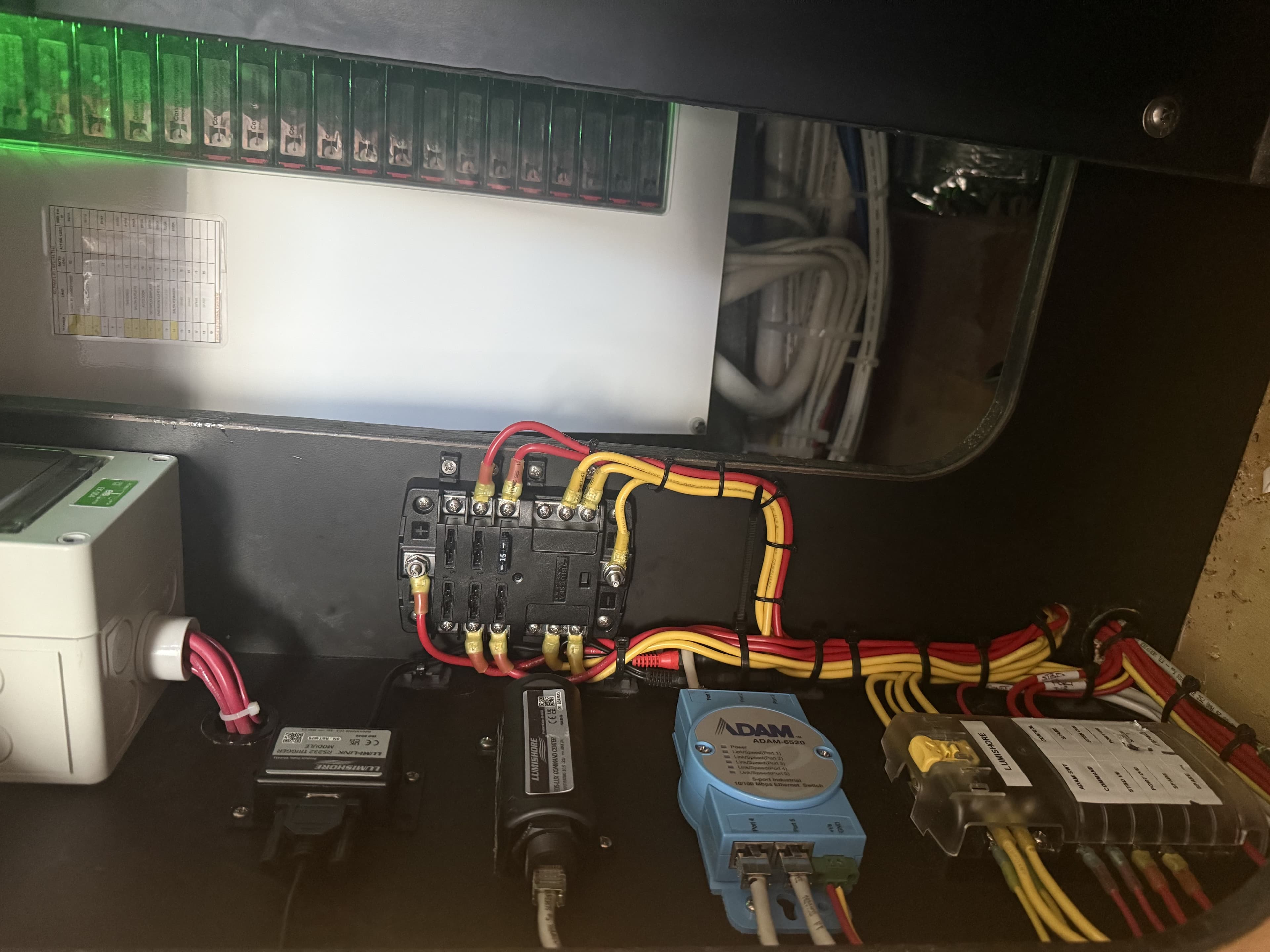 Clean, labeled wiring and equipment bay behind an electronics panel